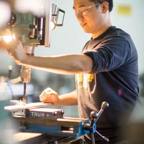 UNH student working with machinery